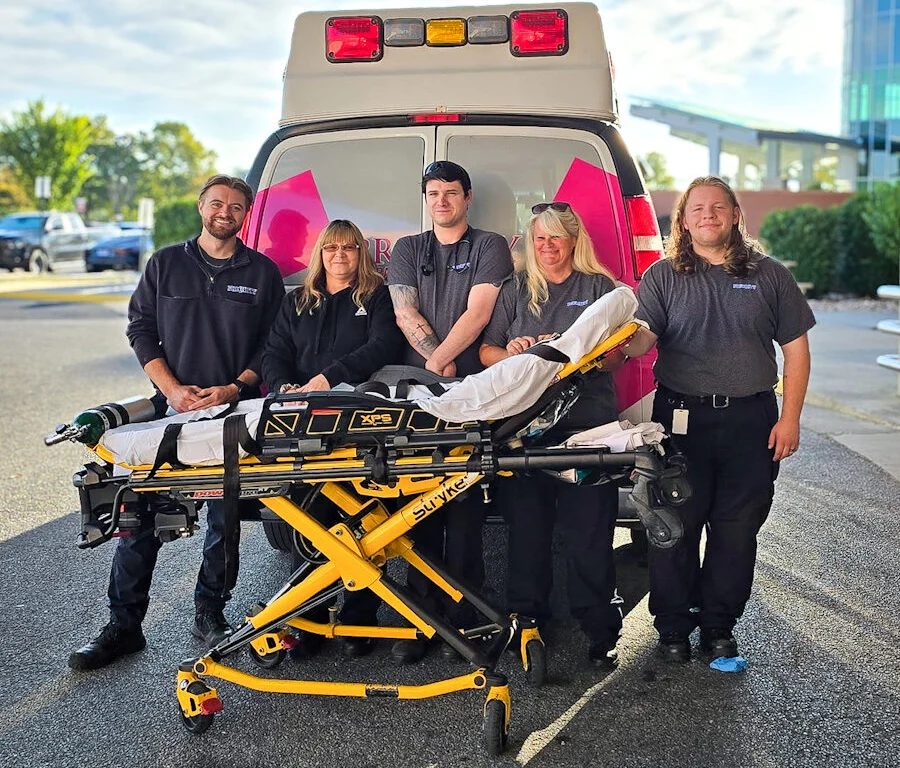 Priority crew smiling outside a hospital