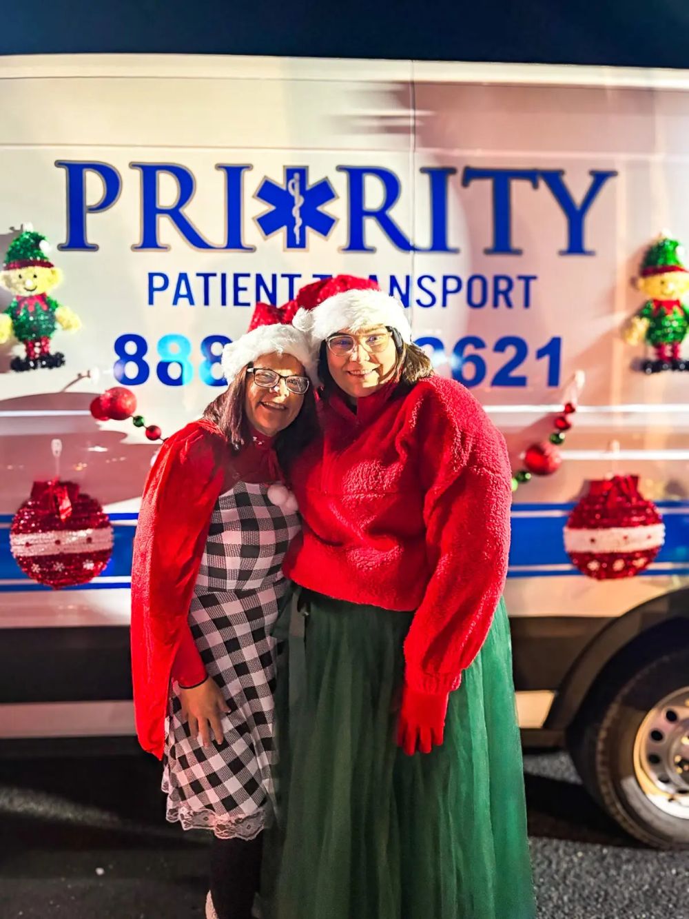 Two EMTs dressed up for a Christmas parade