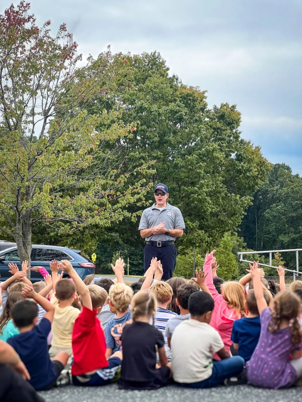 Paramedic educating a group of children
