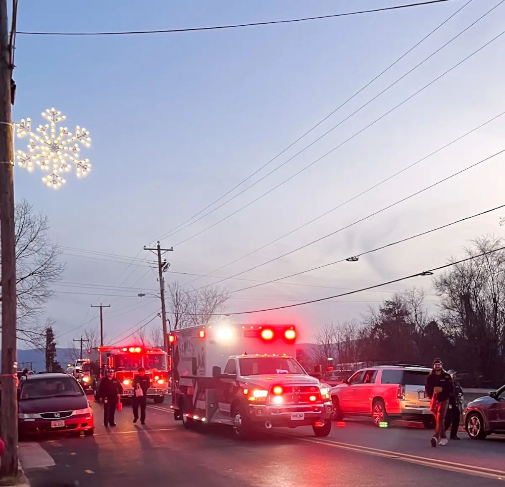 Ambulance with lights on in a parade