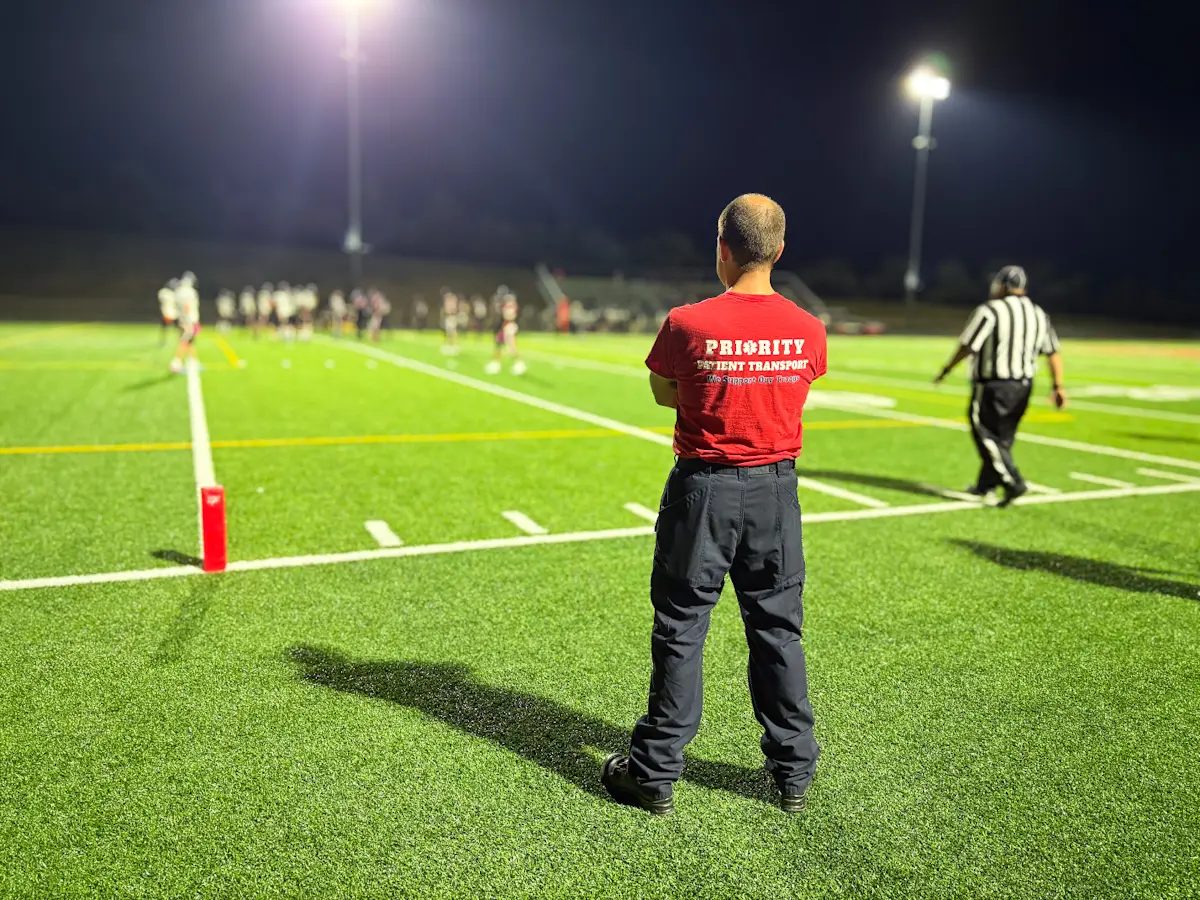 Paramedic on the sideline of a high school football game