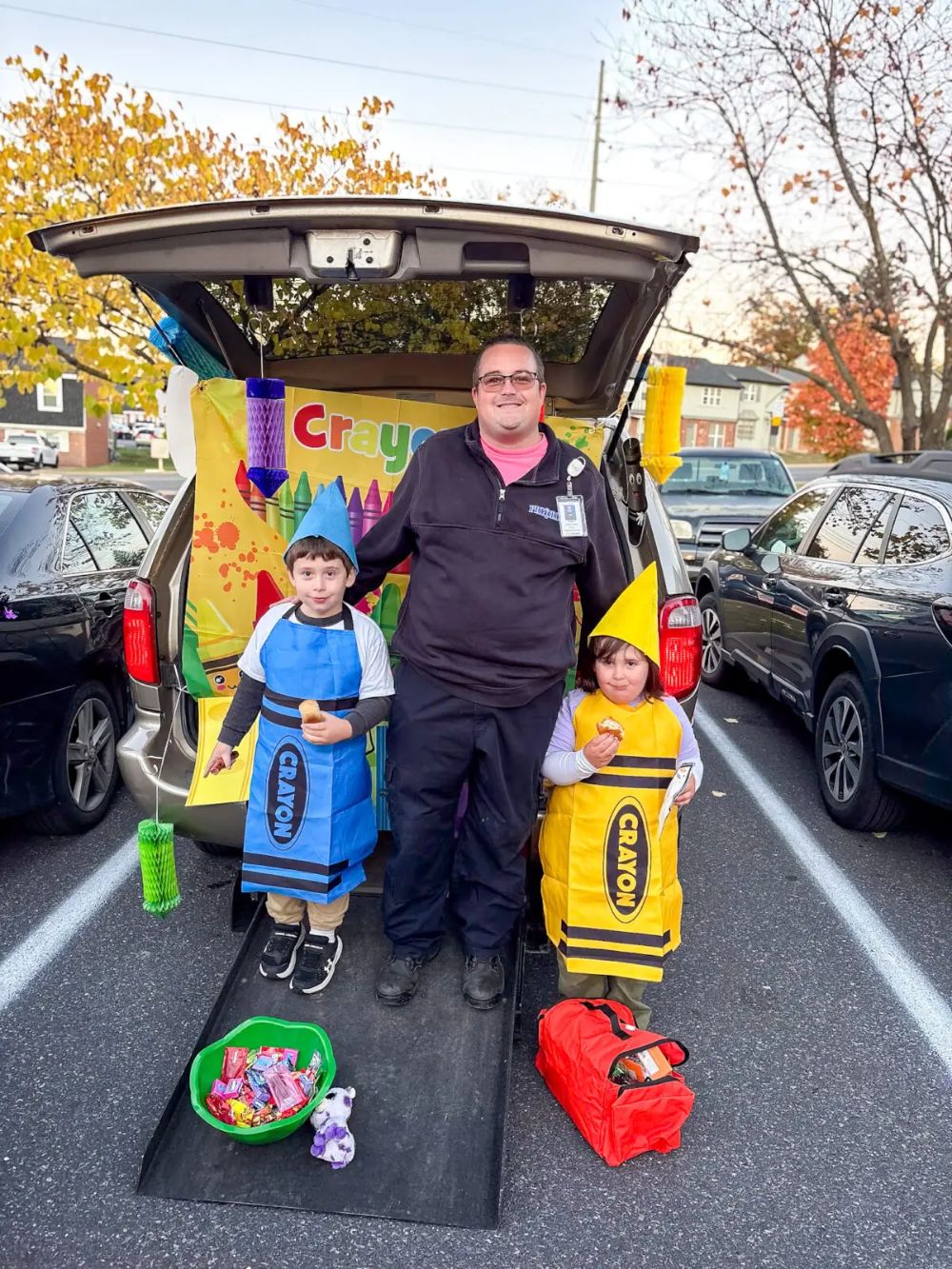 EVOC driver with two children at a trunk-or-treat event